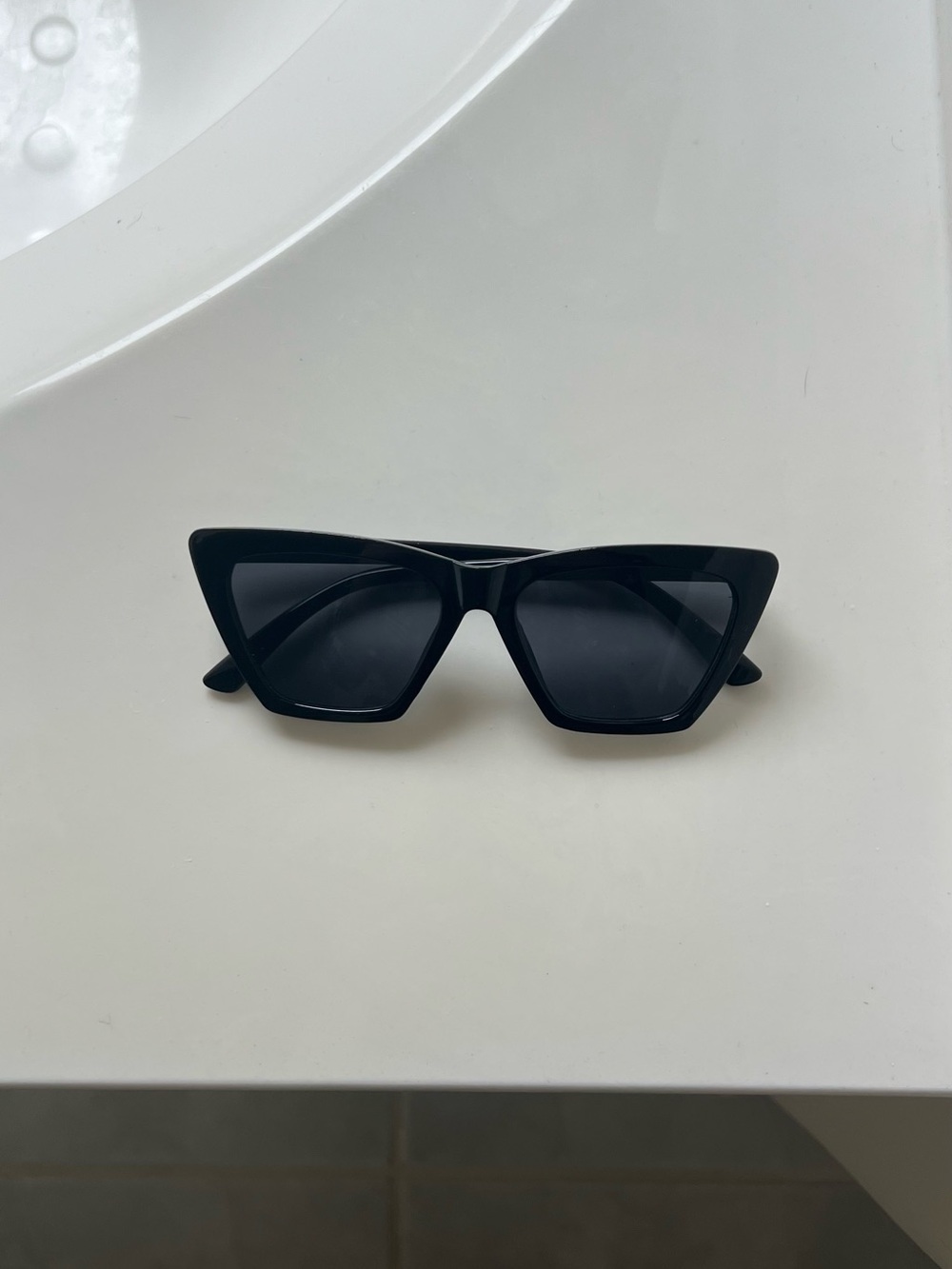 Black cat eye sunglasses with dark lenses
